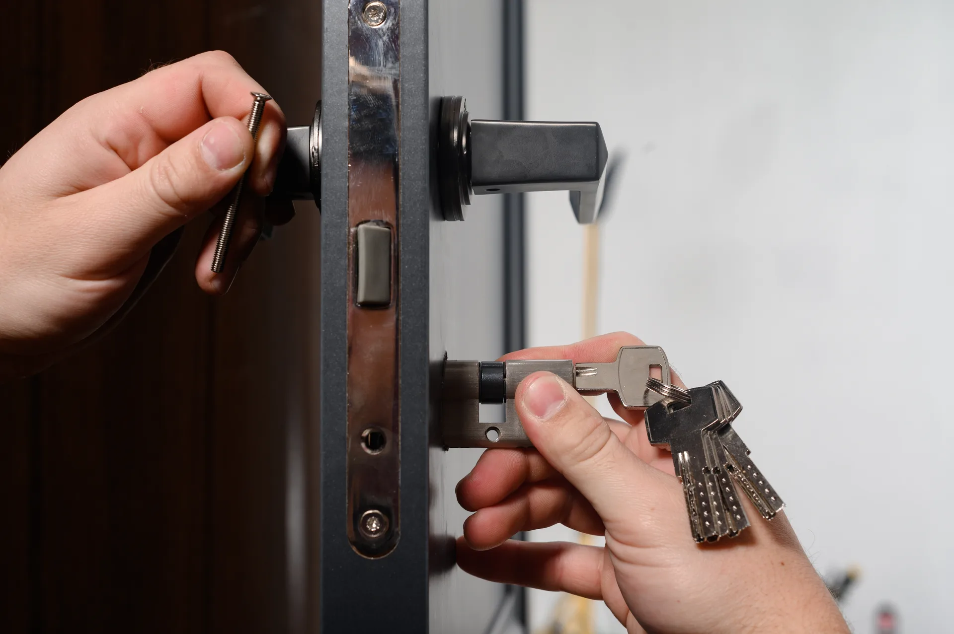 Professional locksmith working on a door lock